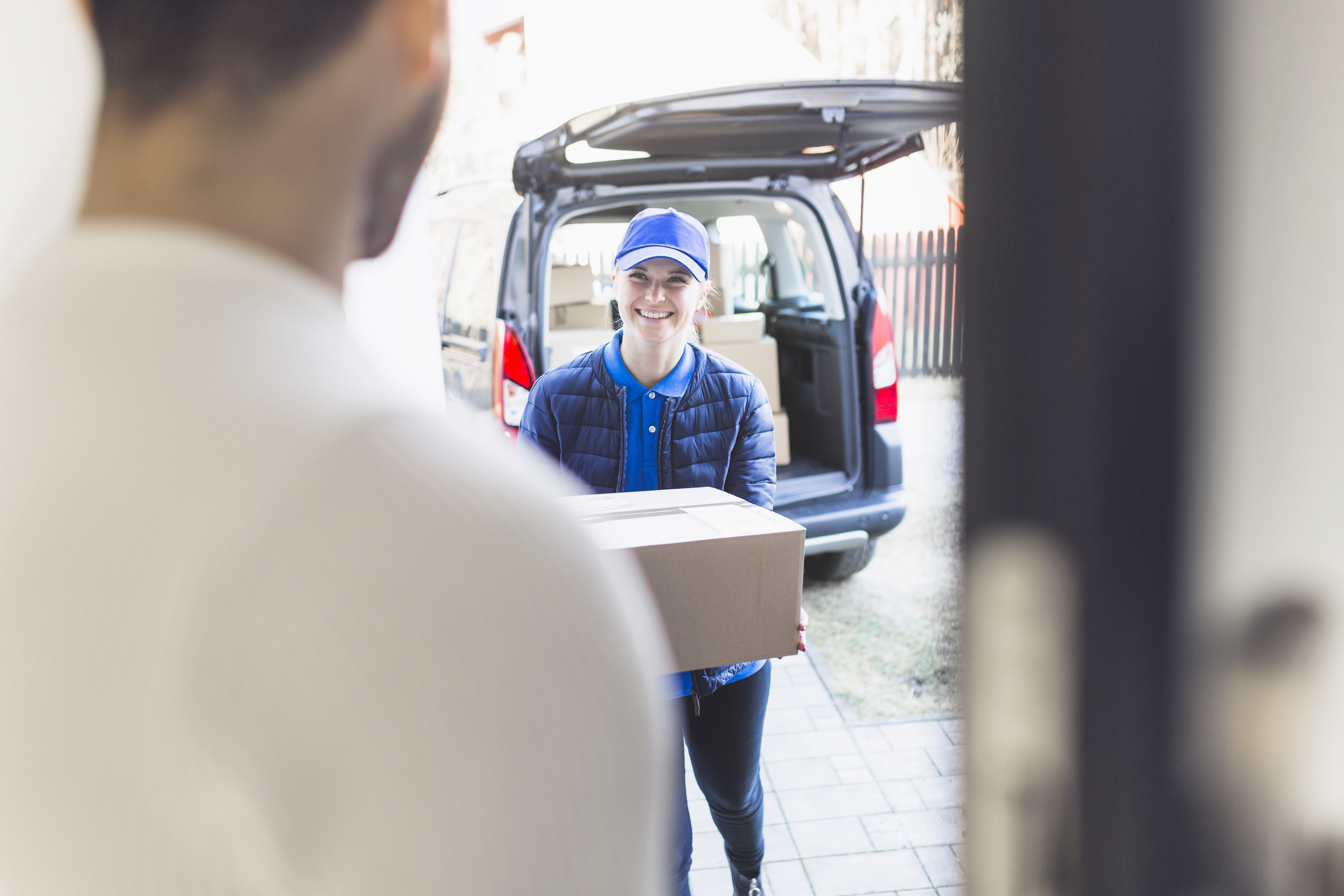 Delivery-girl-carrying-box-customer
